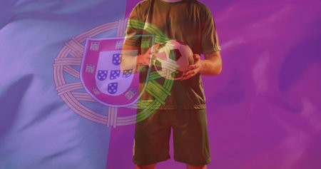 Image of caucasian male soccer player over flag of portugal. Global patriotism, celebration, sport and digital interface concept digitally generated image.の写真素材