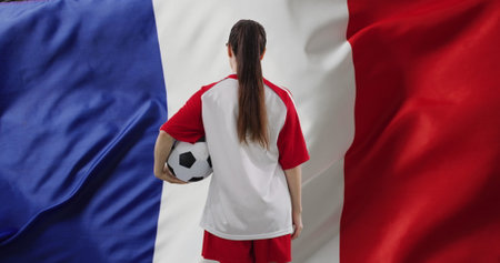 Image of caucasian female soccer player over flag of france. Global patriotism, celebration, sport and digital interface concept digitally generated image.の写真素材