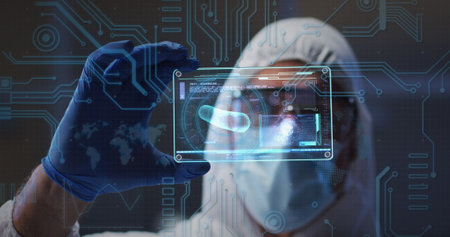 Microprocessor connections against health worker holding futuristic screen with data processing. covid-19 medical research and technology conceptの写真素材