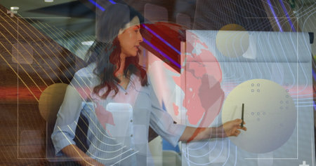 Image of data processing over caucasian businesswoman at meeting. Global business and digital interface concept digitally generated image.の写真素材