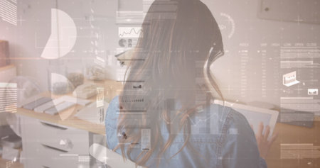 Image of data processing over biracial businesswoman using tablet. Global business and digital interface concept digitally generated image.の写真素材