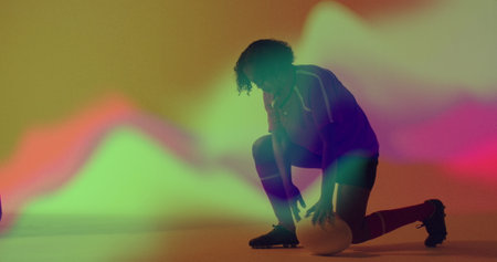 Image of neon light trails over female rugby player on neon background. Sports and communication concept digitally generated image.の写真素材