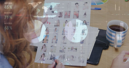 Caucasian colleague examining digital data on transparent screen. She has long brown hair, light skin, and is wearing a casual outfitの写真素材