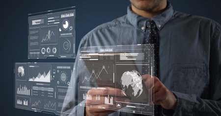 Image of screens with data processing over businessmen using tablet. global business, finances, data...