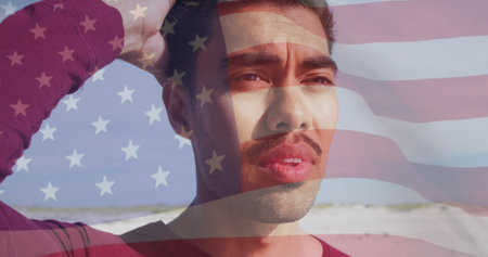 Image of flag of united states of america and biracial man on beach. American patriotism, diversity and tradition concept digitally generated image.の写真素材