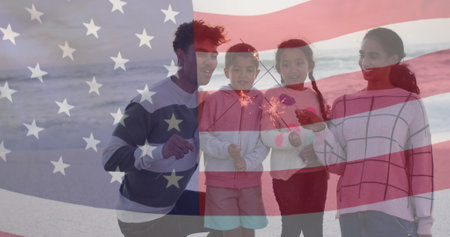Image of flag of united states of america over biracial couple with children by seaside. American patriotism, diversity and tradition concept digitally generated image.の写真素材