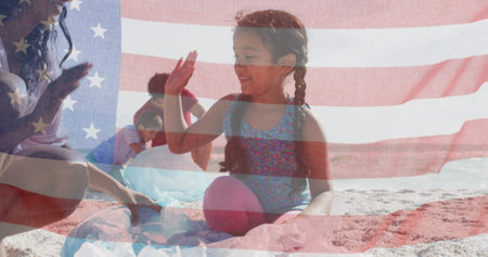 Image of flag of united states of america over biracial couple with children by seaside. American patriotism, diversity and tradition concept digitally generated image.の写真素材