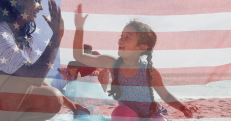 Image of flag of united states of america over biracial couple with children by seaside. American patriotism, diversity and tradition concept digitally generated image.の写真素材