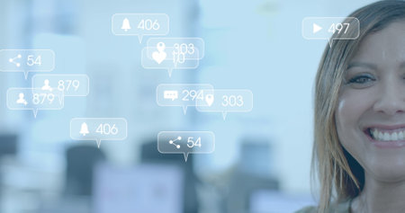 Social media notifications processing over happy biracial casual businessman in office. Casual business, data, digital interface, social network and online communication digitally generated image.の写真素材