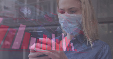 Image of world map and statistic data over caucasian female wearing face mask, using smartphone. global covid 19 pandemic, health and science concept digitally generated image.の写真素材