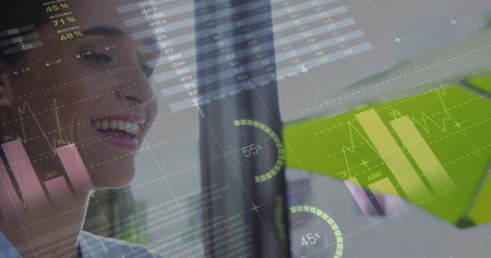 Image of statistics and data processing over woman using laptop. global business, digital interface...