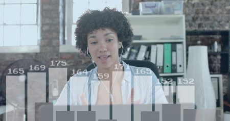 Image of data processing over biracial businesswoman using laptop in office. Global business,...