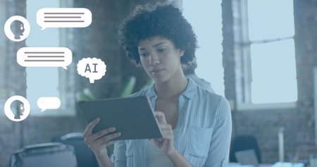 Image of ai chat over biracial businesswoman using tablet in office. Global business, technology and...