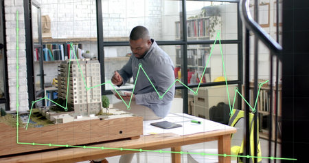 Data processing on graph over african american male architect studying building model. Architecture,...