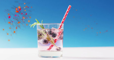 Image of confetti falling and cocktail on blue background. Party, drink, entertainment and celebration concept digitally generated image.の写真素材