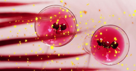 Image of confetti falling and cocktail on pink background. Party, drink, entertainment and celebration concept digitally generated image.の写真素材