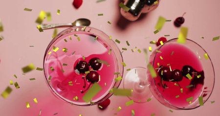 Image of confetti falling and cocktail on pink background. Party, drink, entertainment and celebration concept digitally generated image.の写真素材