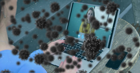 Image of covid 19 cells over businesswoman on laptop image call. global covid 19 pandemic concept digitally generated image.の写真素材