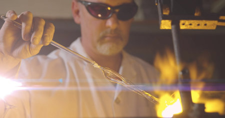 Image of glowing light over caucasian man working in workshop. labor day, work, workers, tradition...