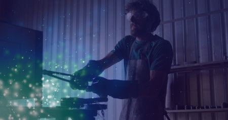 Image of glowing lights over caucasian man working in workshop. labor day, work, workers, tradition...