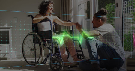 Image of neon heart rate over happy biracial couple, woman on wheelchair. Health and life functions monitoring concept digitally generated image.の写真素材