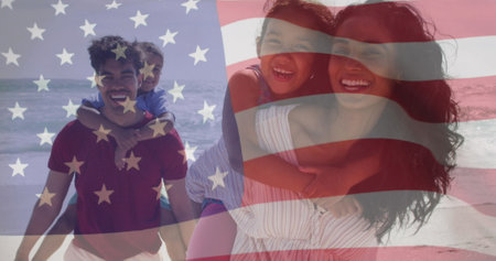Image of flag of united states of america over biracial couple carrying children piggyback. American patriotism, diversity and tradition concept digitally generated image.の写真素材