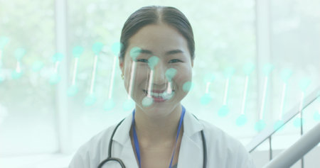 Image of dna strand over portrait of smiling diverse doctors working in hospital. Medical and healthcare services concept digitally generated image.の写真素材