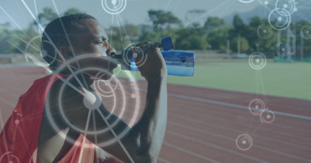 Image of network of connections over male athlete with drinking water on running track. global...