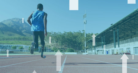 Image of arrows pointing up over disabled male athlete with running blades on running track. global sports, competition, disability and digital interface concept digitally generated image.の写真素材