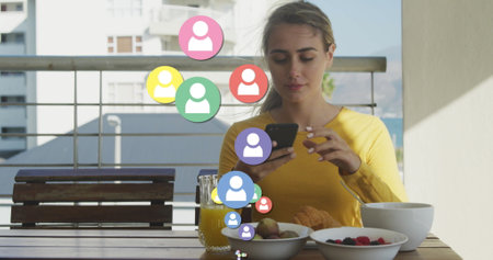 Image of social media icons over caucasian woman taking photos of breakfast with smartphone. social...