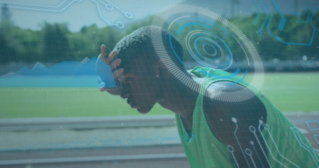 Image of digital data processing over male athlete wiping forehead on racing track. global sports, competition and digital interface concept digitally generated image.の写真素材