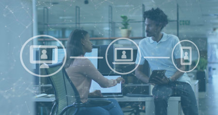 Image of icons and data processing over diverse business people in office. Global business, finances, computing and data processing concept digitally generated image.の写真素材