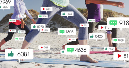 Image of social media notifications, over women doing yoga on beach. positive feelings and wellbeing...