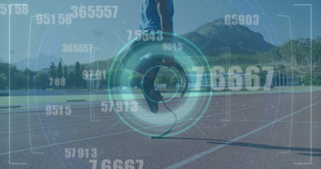 Image of digital data processing over disabled male athlete with running blades on racing track. global sports, competition, disability and digital interface concept digitally generated image.の写真素材