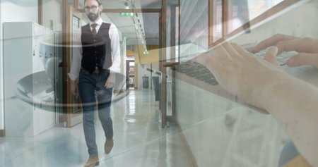 Image of hands of person with coffee using laptop, over businessman walking in office corridor. business and communication technology concept digitally generated image.の写真素材