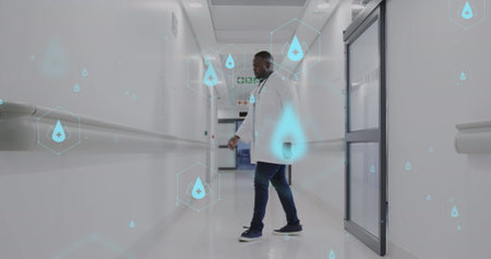 Image of network of medical icons and data processing over african american male doctor. Global science, medicine, research, computing and data processing concept digitally generated image.の写真素材