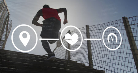 Image of icons over a running african american man. Global connections, wellbeing, fitness and healthy lifestyle concept digitally generated image.の写真素材