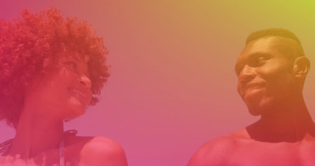 Image of african american couple at beach holding hands and smiling, over colourful light. spending free time together, happy holidays and free time, digitally generated image.の写真素材