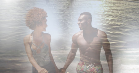 Image of happy african american couple at beach over sea. spending free time together, happy...