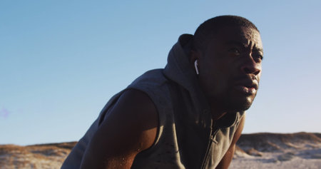 Image of glowing lights over a running african american man. Global connections, wellbeing, fitness and healthy lifestyle concept digitally generated image.の写真素材