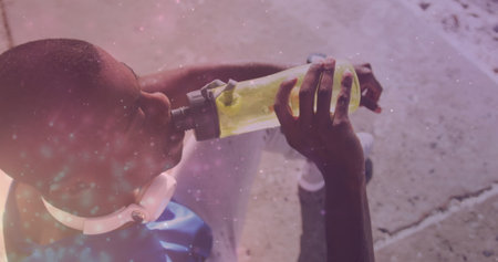 Image of glowing lights over an exercising african american man drinking water. Global connections,...