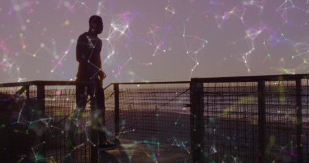 Image of network of connections over a running african american man. Global connections, wellbeing, fitness and healthy lifestyle concept digitally generated image.の写真素材