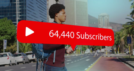 Image of media icons over african american man using smartphone. Global business and digital...