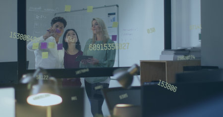 Image of numbers and data processing over diverse business people working in office. Global business, finances, computing and data processing concept digitally generated image.の写真素材