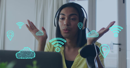 Image of cloud and wifi icons, data processing over woman vlogging. Global cloud computing,...