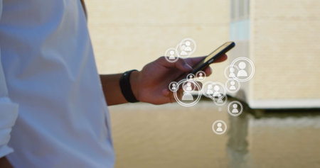 Digital composite of walking man showing only his hands while using a mobile phone. Several vector...