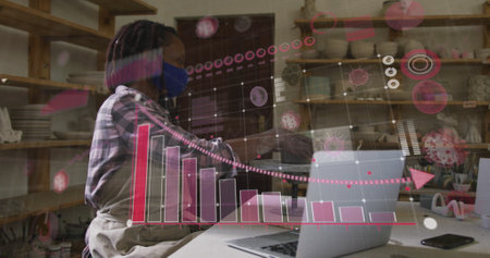 Image of virus cells and data processing over african american woman with face mask and laptop. hobby during covid 19 pandemic concept digitally generated image.の写真素材