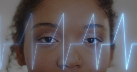 Image of cardiograph over african american female doctor working at hospital. Medicine, healthcare and digital interface concept concept digitally generated image.の写真素材