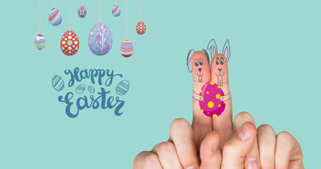 Image of happy easter, eggs and fingers paint as bunnies on mint background. easter, spring, tradition and celebration concept digitlaly generated image.の写真素材