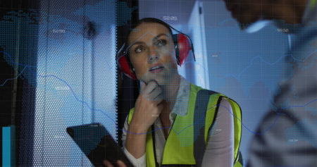 Image of data processing over caucasian female it engineer with tablet checking computer servers. data processing, cloud computing concept and technology concept digitally generated image.の写真素材